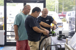 Duval Paint owner helping contractors with a tool