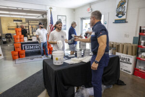 Man giving out a shirt to a contractor