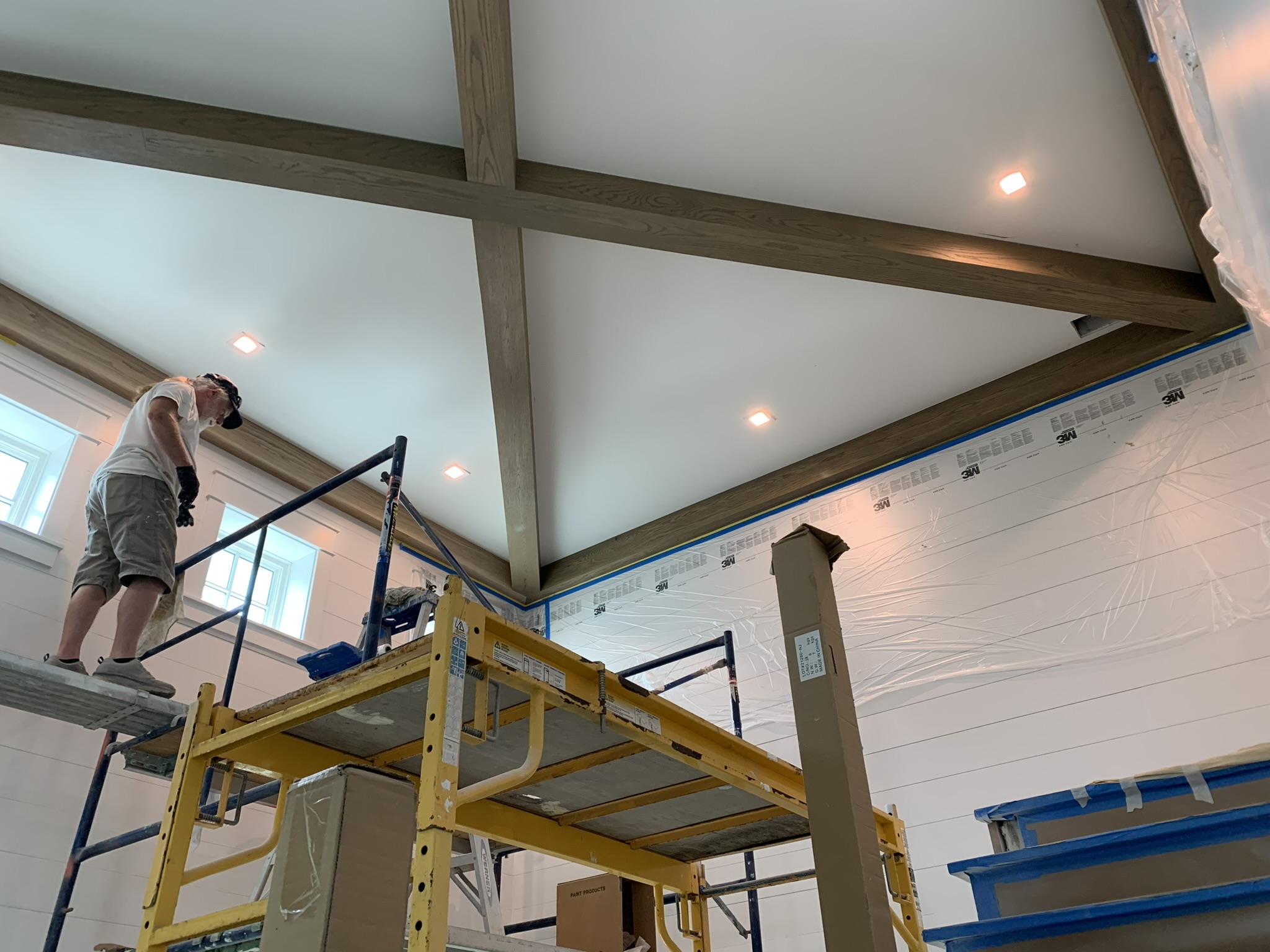 Contractor prepping wall and ceiling area in a home for painting
